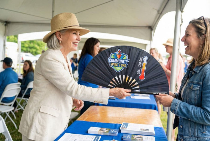Guests holding custom printed hand fans