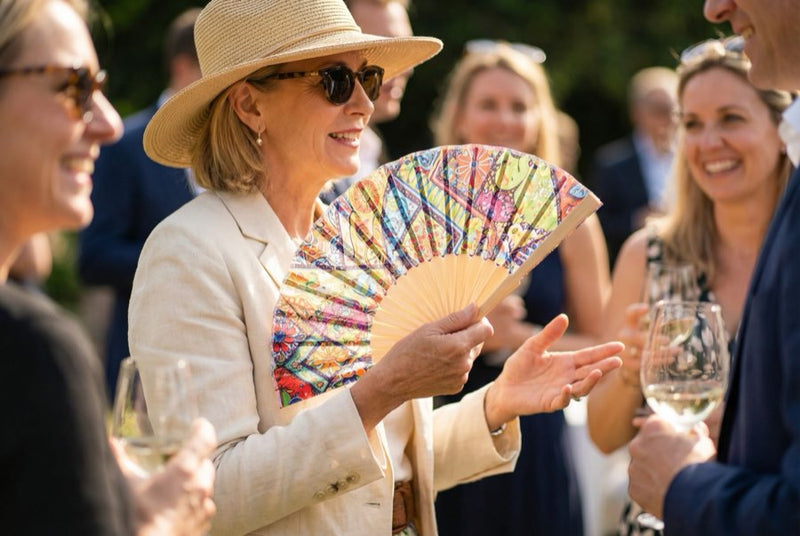Guests holding custom printed hand fans
