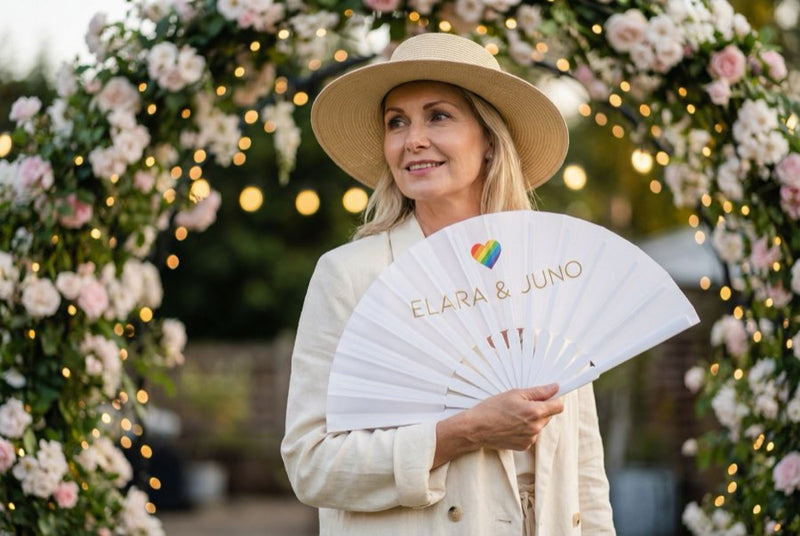 Guests holding custom printed hand fans
