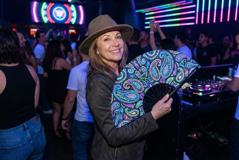 Guests holding custom printed hand fans